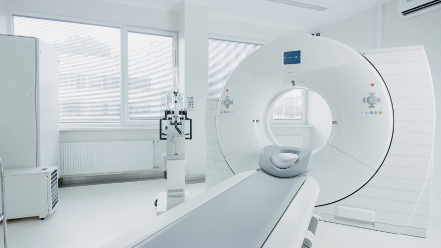 PET/CT scanner in a clean medical imaging room, used for diagnostic scans combining X-rays and positron emission tomograph
